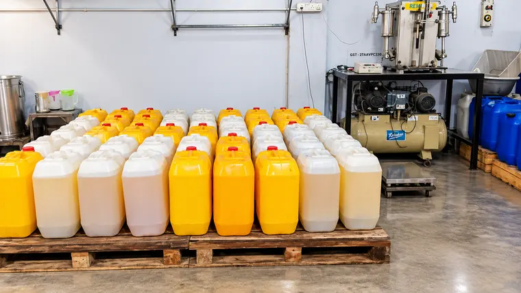 Cans of freshly pressed oil on a pallet