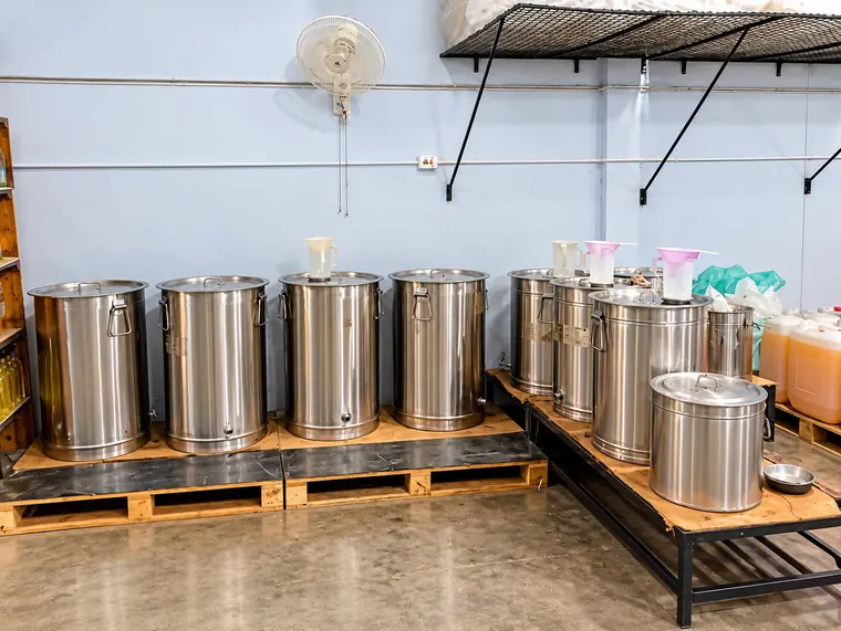 Steel drums where freshly pressed oil settles